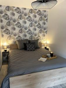 a bedroom with a large bed with a wall at Bel appartement sur cour plein centre ville et parking in Moulins