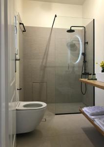 a bathroom with a glass shower and a toilet at serenity villa Aegina fantastic view near the beach in Aegina Town
