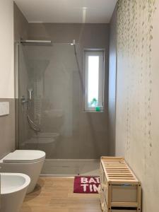 a bathroom with a shower and a toilet and a sink at Mariluna in Modugno