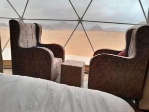 two chairs in a tent looking out at the desert at Moon Rum Camp in Wadi Rum