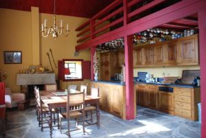 a kitchen with a wooden table and a dining room at Cardenha do Douro in Mesão Frio