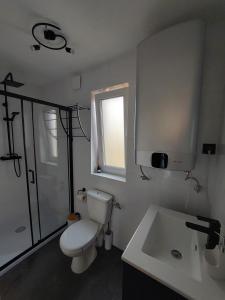 a white bathroom with a toilet and a sink at Spokojny zakątek in Ustroń +20 photos