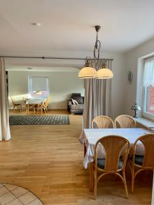 a dining room and living room with a table and chairs at Ferienhaus Anna in Dagebüll