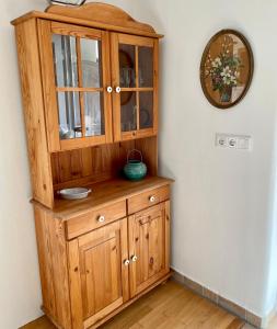 a wooden cabinet in the corner of a room at Ferienhaus Anna in Dagebüll