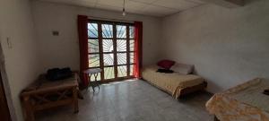 a room with a bed and a large window at Bellos Milagros in Santa María