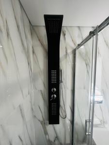 a shower in a bathroom with a black and white at Encosta do Gerês Village in Braga