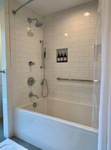 a bath tub in a bathroom with a shower at Rig Veda House - Saratoga Estate Property 