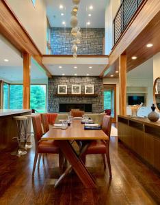 a dining room with a wooden table and chairs at Rig Veda House - Saratoga Estate Property 