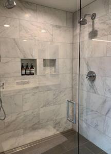 a bathroom with a shower with a glass door at Rig Veda House - Saratoga Estate Property 