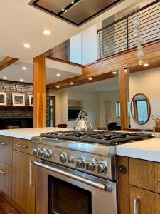 a kitchen with a stainless steel stove top oven at Rig Veda House - Saratoga Estate Property 