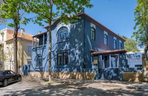 a blue building with a car parked in front of it at Casa da Marechal - Boutique Hotel by Oporto Collection - Adults Only in Porto