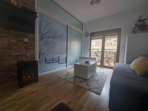 a living room with a couch and a fireplace at Cosy apartment in Mavrovo in Mavrovo