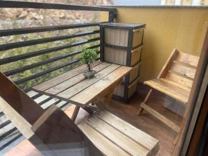a wooden table and a bench on a balcony at Cosy apartment in Mavrovo in Mavrovo