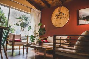 a living room with a couch and a clock on the wall at Casa Suiza in Santa Cruz
