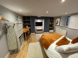 a bedroom with a bed and a desk in it at Apple Street Cottage in Oxenhope