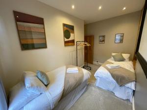 two twin beds in a room with at Apple Street Cottage in Oxenhope