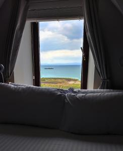 a view of the ocean from a window at Portrush by the Sea - 6 Golf Terrace in Portrush