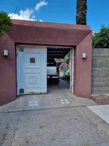 a garage with a car parked inside of it at La Palmera in Deán Funes
