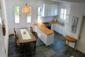 a kitchen with a table and a table and chairs at Spetses Cozy Villa in Spetses
