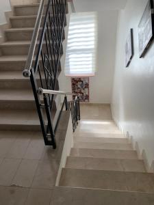 a stairway with a black railing and a stair case at Apartment Lena in Vodice