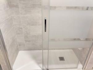 a shower with a glass door in a bathroom at Stylish flat and pool with 3 rooms, sleeps 6, Los cristianos in Los Cristianos +7 photos