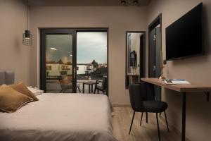 a bedroom with a bed and a desk with a computer at Rooms "Limes" in Funtana