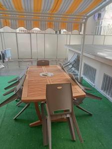 a wooden table and chairs in a tent at CarloAlbertoApartmentsrooms in Ancona