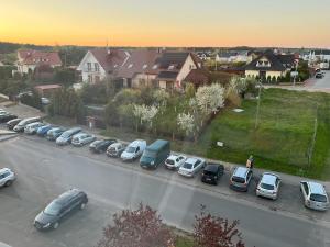 a group of cars parked in a parking lot at Osiedle Leśne 37/28 in Oborniki