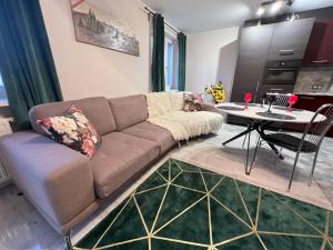 a living room with a couch and a table at Osiedle Leśne 37/28 in Oborniki
