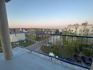 a balcony with a view of a city at Osiedle Leśne 37/28 in Oborniki