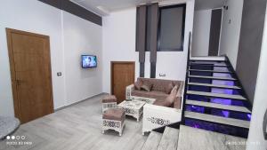 a living room with a staircase and a couch at Kelibia, Tunisie in Kelibia