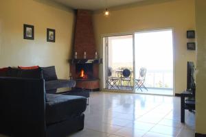 a living room with a couch and a fireplace at La petite maison sur la colline - Benslimane 