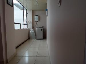 un pasillo vacío con una habitación con nevera en Apartamento ideal si buscas ubicación y espacio, en Pereira