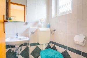 a bathroom with a sink and a toilet at STUDIO in Omišalj