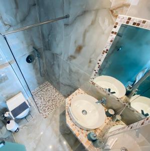 a bathroom with a shower and a toilet and a sink at Cocoon Hotel-Beach bar in Sarti