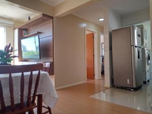 a kitchen with a stainless steel refrigerator and a dining room at AP Moderno in Pelotas