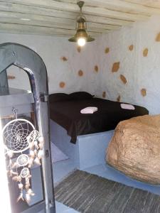 a small bed in a room with a ceiling at Artemis Studio Pyrgi in Mikonos