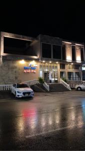 a car parked in front of a building at night at New Day Resort منتجع يوم جديد in Taif
