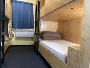 1 Schlafzimmer mit 2 Etagenbetten und einem Fenster in der Unterkunft Fox Glacier Jade Hotel in Fox Glacier