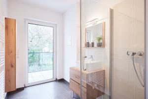a bathroom with a shower and a sink and a mirror at Apartments nähe Schloss Schönbrunn in Vienna +119 photos