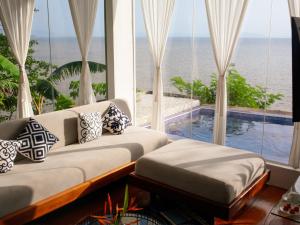 a living room with a view of the ocean at The Dream Beach Resort in Taytay