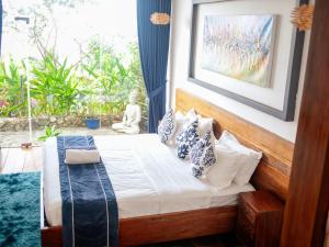 a bedroom with a bed with pillows on it at The Dream Beach Resort in Taytay