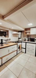 a large kitchen with white appliances in a room at Departamento SUR in Ushuaia