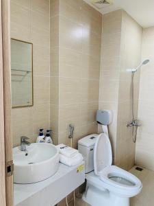 a bathroom with a white toilet and a sink at Nera House in Hue