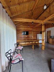Una habitación con dos sillas y una mesa y un televisor. en Recanto Pôr do Sol, en Urubici