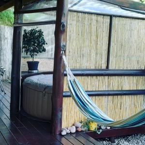 a hammock in a gazebo on a deck at El Miyagi in Piriápolis