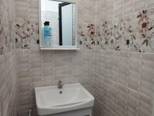 a bathroom with a sink and a mirror at Inap Idaman 4 Near Hospital HUSM Kubang Kerian in Kota Bharu