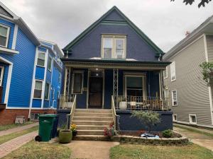 a blue house with stairs in front of it at Bright, big family escape, W/parking, dogs welcome in Oak Park