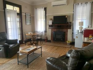 a living room with a couch and a fireplace at The Light Horse Hotel in Harden