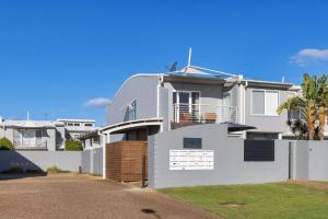 a white house with a fence in front of it at Sandcastles at the Beach - Linen Supplied & Beds Ready on Arrival in Fingal Bay